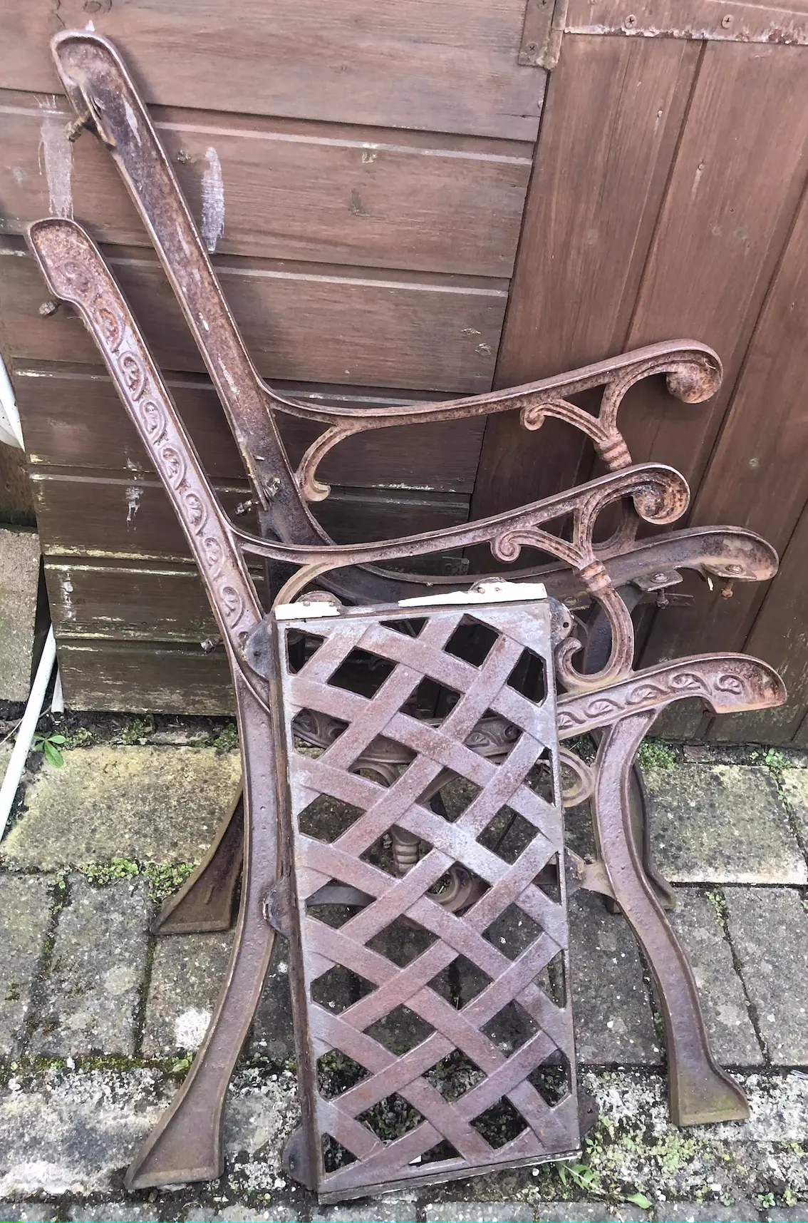 rusted sides and back of an old metal garden chair